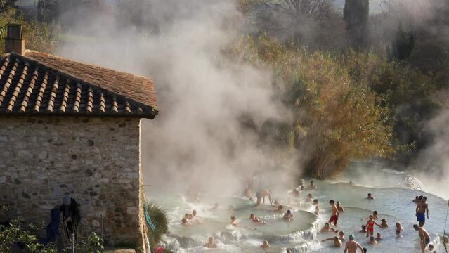 People bathing in Terme di Saturnia hotsprings in the region of Tuscany, in Italy