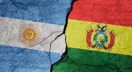 Argentina and Bolivia flags on a stone wall with a crack, illustration of the concept of global crisis in political and economic relations