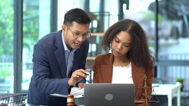Teamwork of business lawyer meeting working hard about legal legislation in courtroom to help their customer.