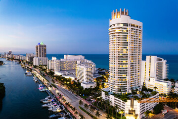 Miami Beach, Florida, USA - Evening aerial of the Fountainebleau, luxury condominiums and hotels along Indian Creek Driver spanning from Mid Beach to North Beach.