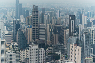 Obraz premium Bangkok cityscapes, skyline, high rise office buildings and skyscrapers in Bangkok city, winter daylight, top view behind pollution haze or PM 2.5 in winter season, Bangkok, Thailand