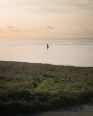 A yacht in the calm sea at sunrise