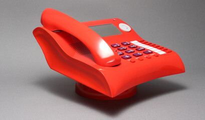 Close up telephone landline isolated at office concept. Stylish curvy design, red color, Italian...