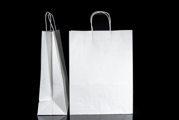 Recyclable craft paper bag for purchases, gifts and takeaway food mock up on black background....