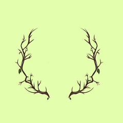 two leafy wood branches form a circle resembling deer antlers on a green background