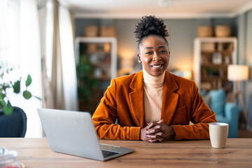 Happy smiling businesswoman small business owner, company leader or sales manager, female CEO executive, successful entrepreneur looking at camera sitting in home office.
