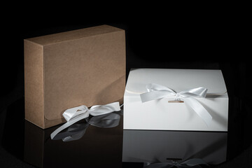 gift box decorated with a white bow on an isolated black background with a clipping path