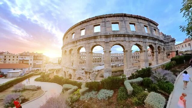 Pula, Istria, Croatia - August 2022: Pula Amphitheater at sunset, also known as Coliseum of Pula, is a well-preserved Roman amphitheater in Pula, Istria, Croatia. An ancient arena of the Roman Empire.