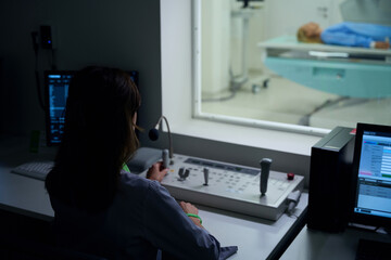 Experienced radiologic technologist is performing x-ray examination of patient © Viacheslav Yakobchuk