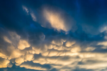 Bizarre, cotton-like clouds in a dark blue sky