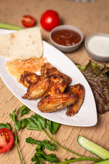 shish kebab of chicken wings on a white plate