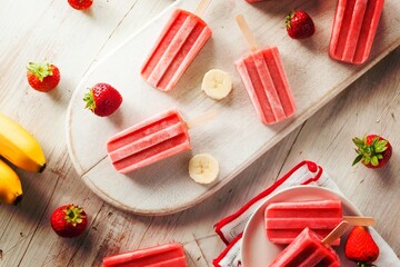 Fototapeta na wymiar Homemade Strawberry and Banana Popsicles on a Stick