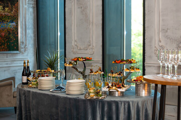 various snacks on stands on the buffet table. self-service at the event