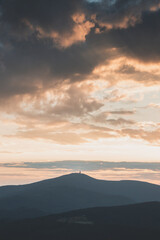 Dramatic sunset with rainy clouds over Lysa Hora peak Beskydy mountains, Czech Republic