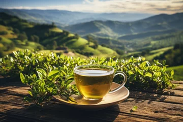 Tuinposter Cup of green tea on wooden table with background of tea plantation, soft morning light colors, copy space.  © Katerina Bond