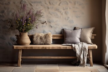 A rustic entryway with a weathered wooden bench, adorned with hand-knit throw pillows and...
