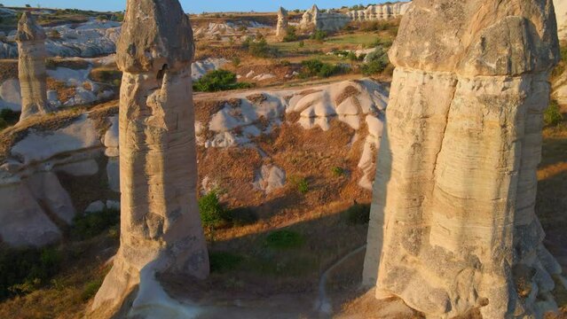 In this mesmerizing aerial stock video, we traverse Love Valley, Cappadocia, Turkey, where nature's artistry has carved a surreal landscape of distinct-shaped rocks.