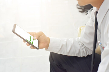 Man holding smartphone with blank screen indoors, closeup of hands