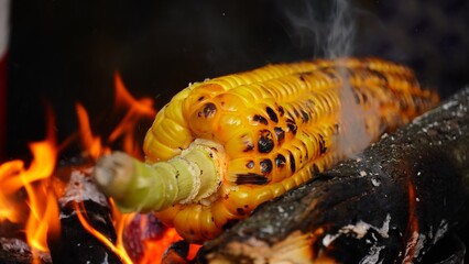 a corn is grilled on the coal
