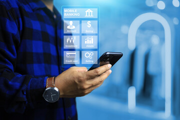 Mobile banking concept with man hand holding mobile phone to using application and transfer or transaction money on smart devices