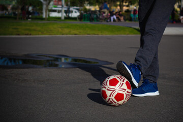 senior pensioner man with a soccer ball on a field in a park