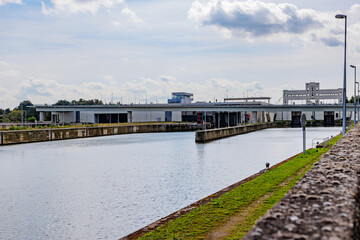 Canal towards Lanaye lock complex with closed floodgates, Albert canal, construction walls,...