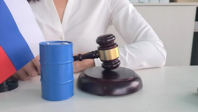 Judge gavel and Russian flag and barrel of oil. Sanctions embargo and export and ban of petroleum products and gasoline
