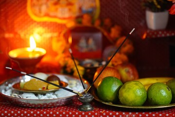 photograph of incense sticks, puja thali, flowers or garlands, Diya on mandir