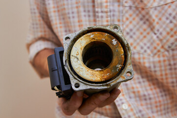 the old circulation pump of the boiler is in hand,the plumber shows the condition of the...