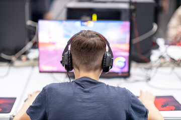 Young gamer playing online computer video game. Video game addiction concept.