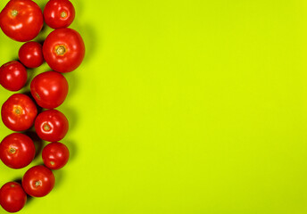 Fresh red tomatoes on a green background, tomatoes for salad
