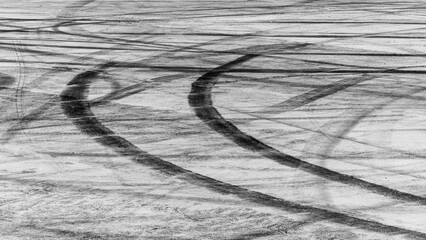 Obraz premium Tire track mark on asphalt tarmac road race track texture and background, Abstract background black tire tracks skid on asphalt road in racing circuit, Tire mark skid mark on asphalt road.