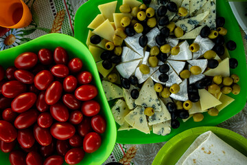 Tomatoes, olives and cheese on the festive table top view close-up life style