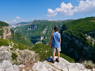 Boy admiring breathtaking view of Nivica canyon, Albania.