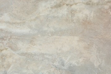 Background and texture of gray with  beige stains cement surface of walls and floor in the interior.