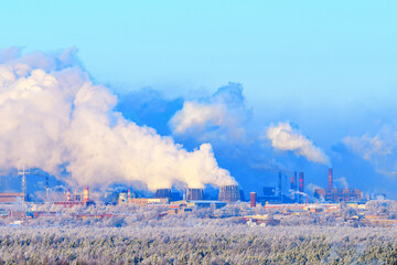 Fototapeta na wymiar Air pollution from steel plant chimneys. Destruction of the ozone layer of the atmosphere, release of smoke poisons, environmental disaster. Winter background, frost.