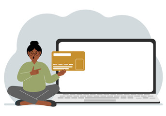 A woman sits cross-legged and holds a large plastic card. Next to the woman is a large laptop with space for text.