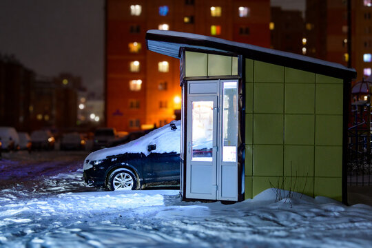  Night kiosk or night market in the city in the courtyard of multi-storey residential buildings. Night trade in winter.