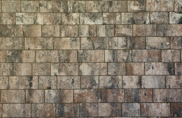 Marble tiles on brick floor or wall background with grey and brown colors front or top view close up