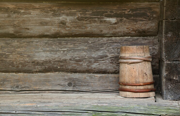 Old wooden barrel in corner of old wooden house close up
