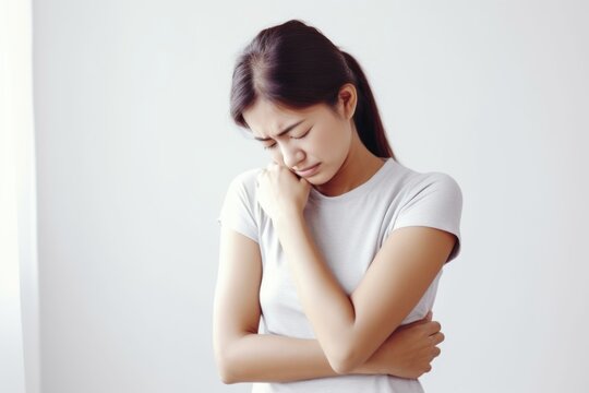 A woman is seen deep in thought, with her hand resting on her chin. This image can be used to portray contemplation, decision-making, or problem-solving