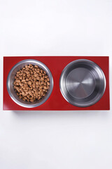 Dry dog and cat food in metal bowl, top view and flat lay