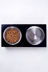 Dry dog and cat food in metal bowl, top view and flat lay