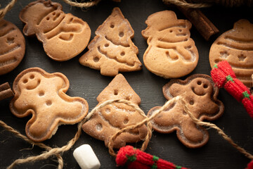 Fototapeta na wymiar Christmas cookies, decorations on dark background. Close-up. Christmas and New Year traditions concept