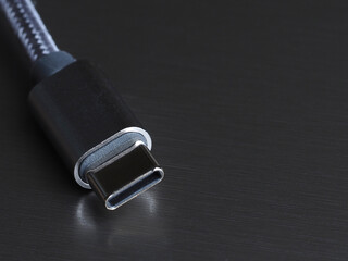 USB Type-C cable on a dark background, close-up, selective focus