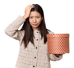 Chinese woman with heart box for Valentine's being shocked, she has remembered important meeting.