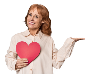 Middle-aged Caucasian woman with Valentine's hear shouting and holding palm near opened mouth.