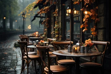 Fotobehang Under the autumn night sky, a charming outdoor dining experience awaits at the street-side cafe with a cozy coffee table and chairs © familymedia