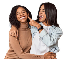 Joyful young Latina friends laughing and joking together
