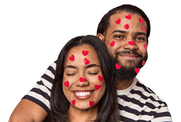 Young Latin couple with heart stickers, joyful, Valentine's